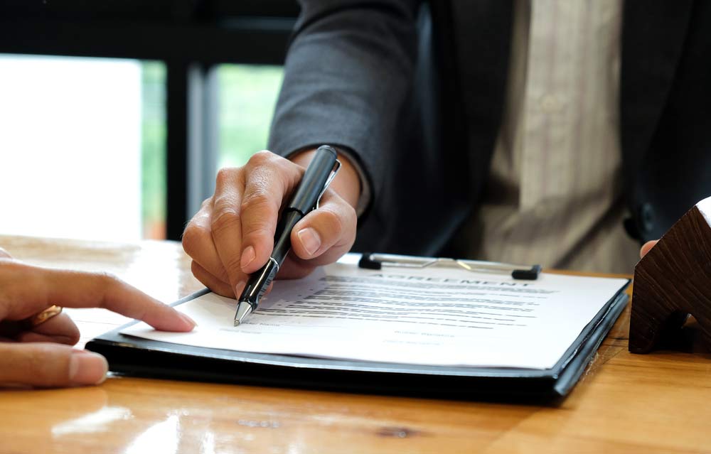 photo of man signing bankruptcy payment plan contract